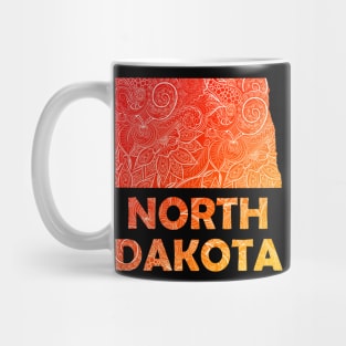 Colorful mandala art map of North Dakota with text in red and orange Mug
